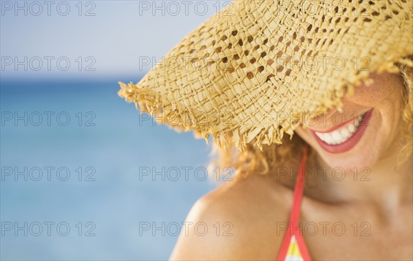 Close up of smiling woman in sun hat.