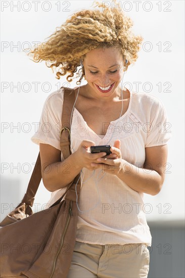 Young woman walking with headphones.