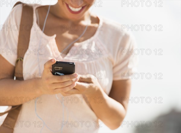 Young woman using mobile phone.