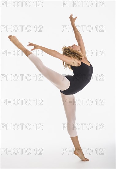 Female ballet dancer during practicing, studio shot.