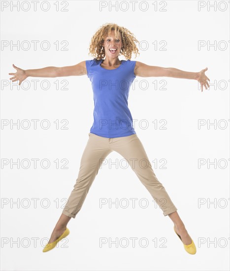 Woman jumping, studio shot.