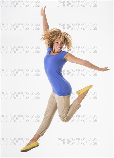 Woman jumping, studio shot.