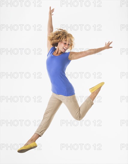 Woman jumping, studio shot.