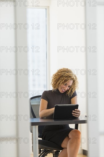 Businesswoman working at desk in office.