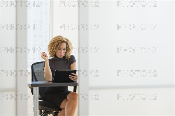 Businesswoman working at desk in office.