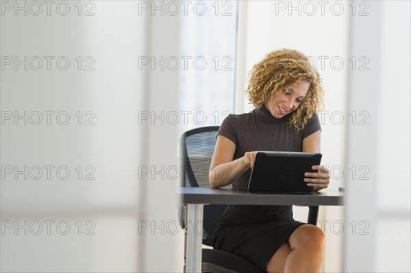 Businesswoman working at desk in office.