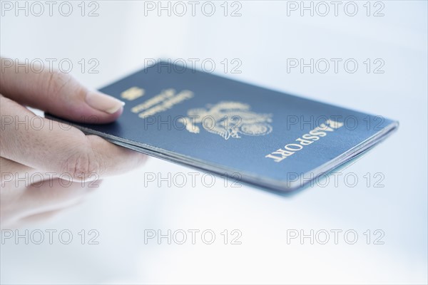 Close up of woman's hand holding passport.