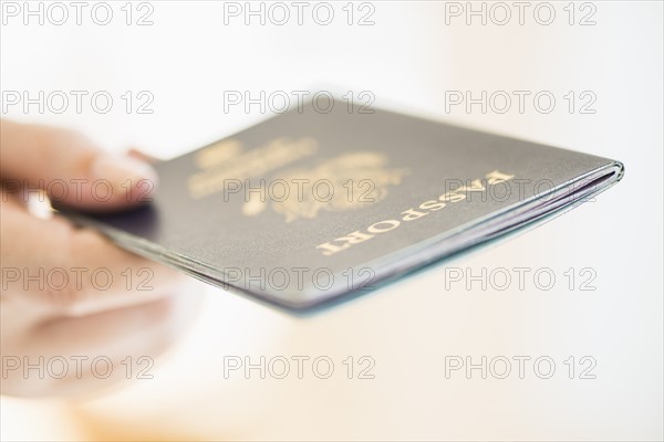 Close up of woman's hand holding passport.