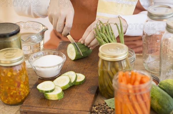 Woman preparing vegetables to preserve it.