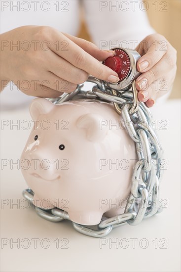 Piggybank closed with chain and combination lock.