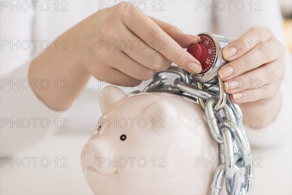 Piggybank closed with chain and combination lock.