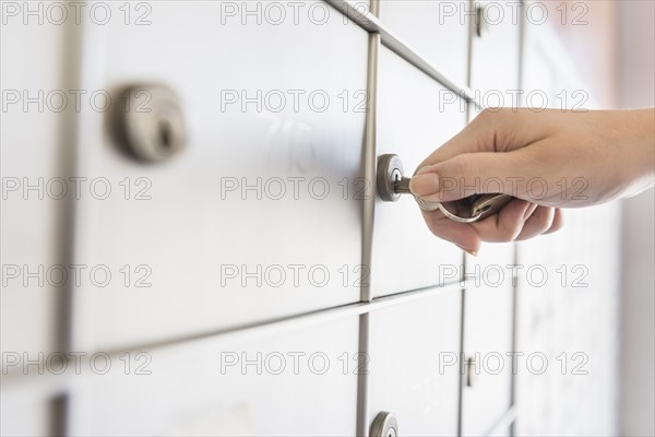 Woman opening safety deposit box.