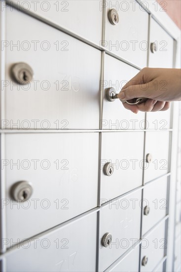 Woman opening safety deposit box.