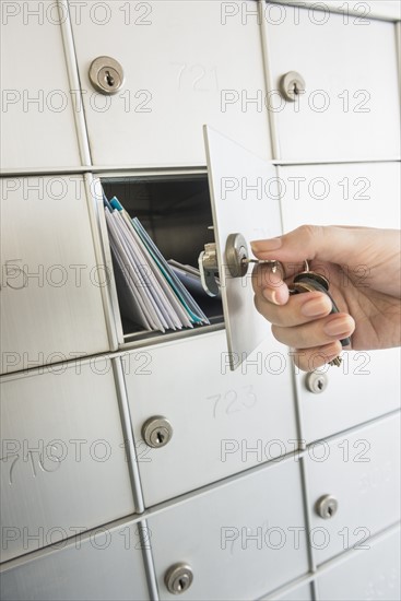 Woman closing safety deposit box.