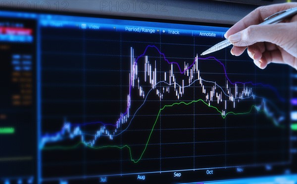 Studio shot of woman pointing at chart.