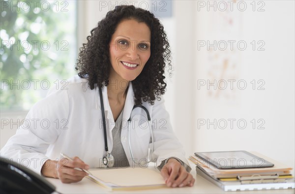 Portrait of doctor sitting in office.