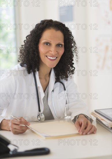 Portrait of doctor sitting in office.