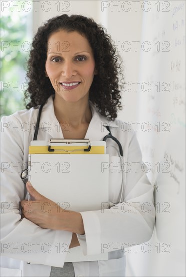 Portrait of doctor standing in office.