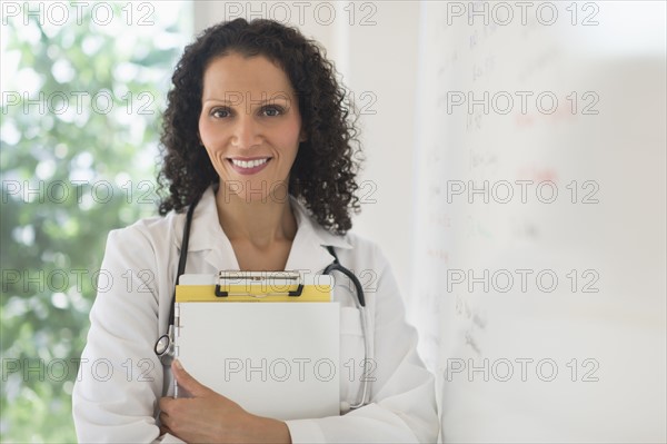 Portrait of doctor standing in office.