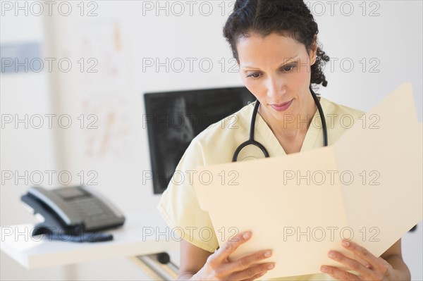 Portrait of doctor reading documents.
