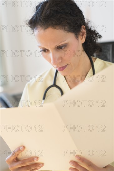 Portrait of doctor reading documents.