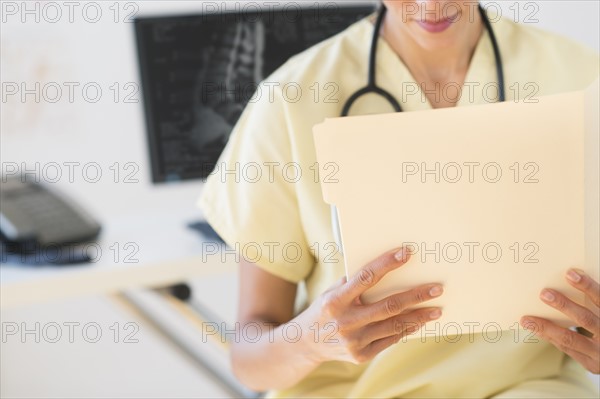 Portrait of doctor reading documents.