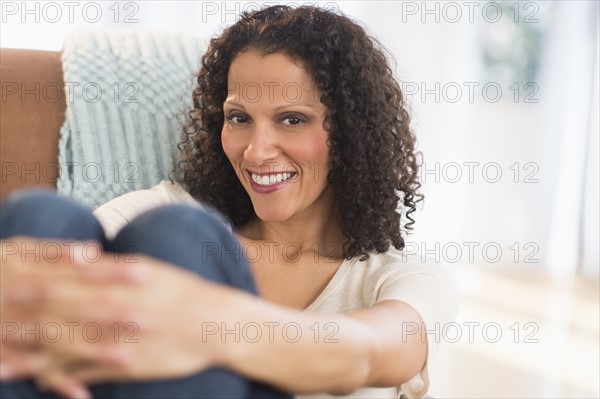 Portrait of woman sitting in living room.