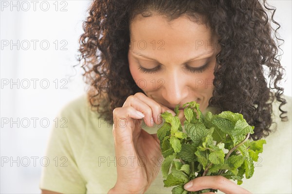 Woman smelling fresh mint.