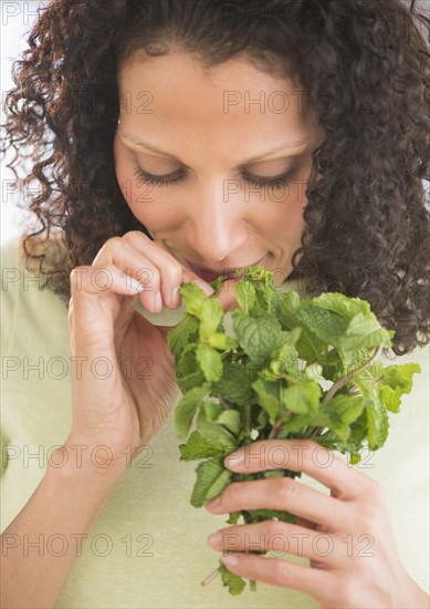 Woman smelling fresh mint.