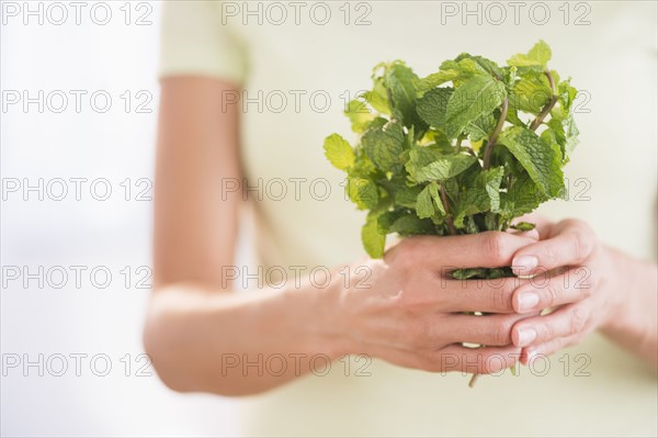 Woman holding fresh mint.