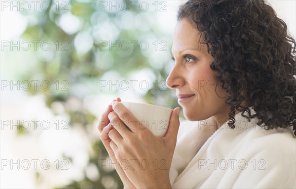 Woman relaxing with cup of coffee.