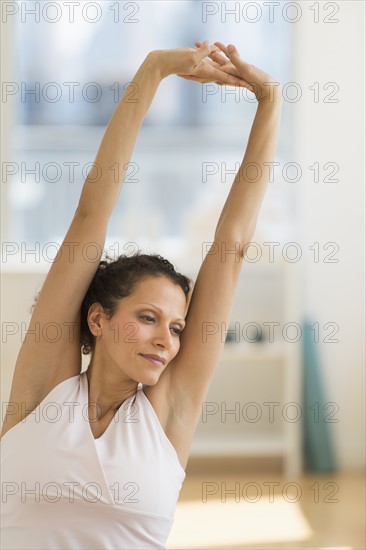 Portrait of woman stretching on exercise ball.