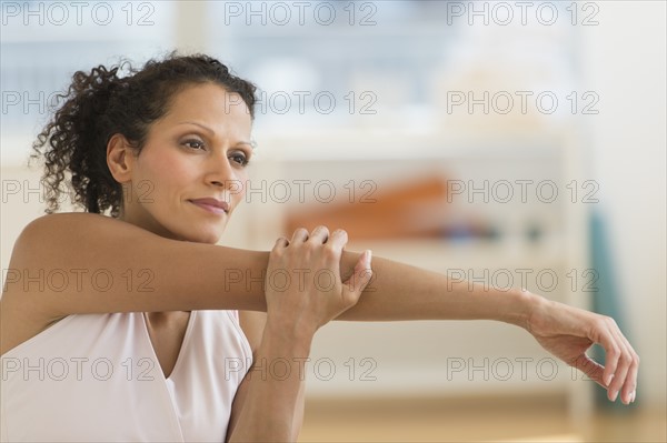 Portrait of woman stretching on exercise ball.