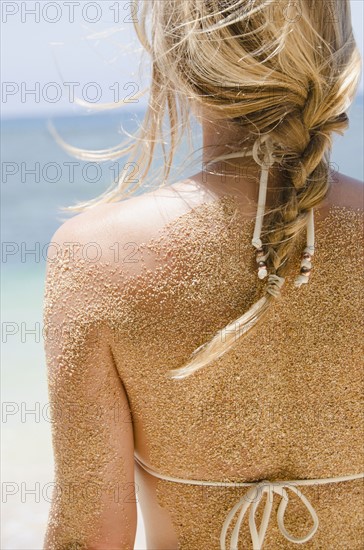 Woman's back with sticking sand . Photo: Jamie Grill