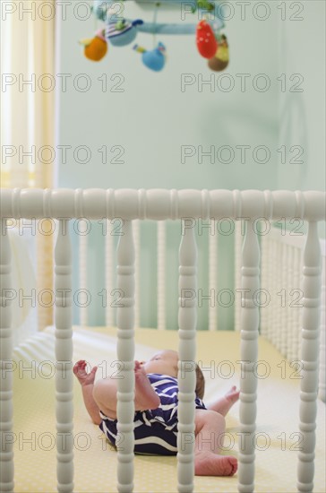 Baby girl (2-5 months) in crib. Photo : Jamie Grill