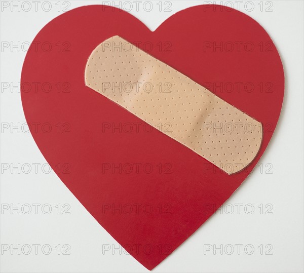 Studio shot of heart with adhesive bandage. Photo: Jamie Grill