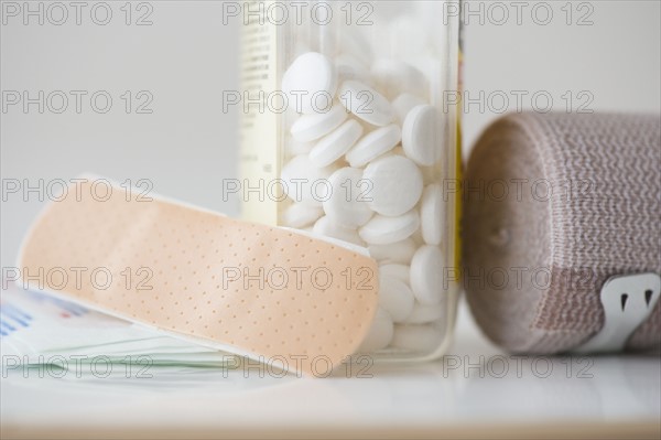 Studio shot of pills, bandage and adhesive bandage. Photo : Jamie Grill