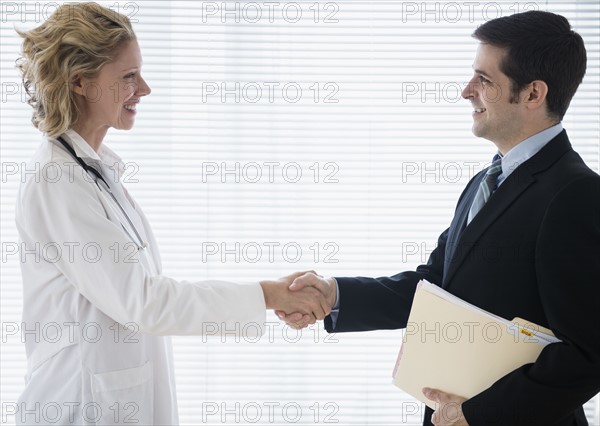 Female doctor greeting office worker. Photo : Jamie Grill