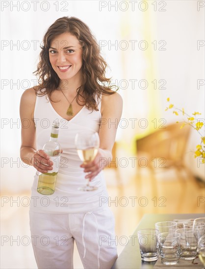 Woman pouring wine to glass. Photo : Daniel Grill