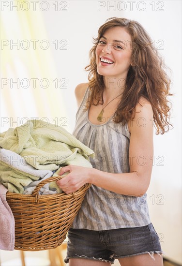 Woman carrying laundry basket. Photo: Daniel Grill