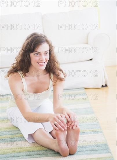 Young woman exercising at home. Photo: Daniel Grill