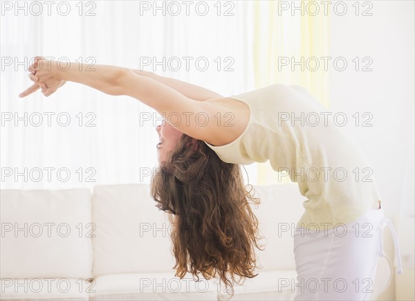 Young woman exercising at home. Photo : Daniel Grill