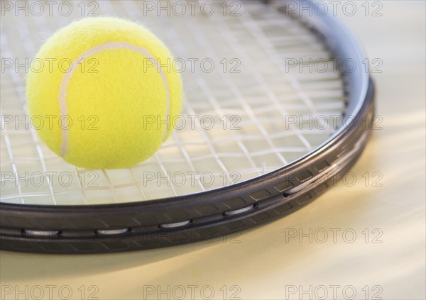 Studio Shot of tennis racket with ball. Photo : Daniel Grill