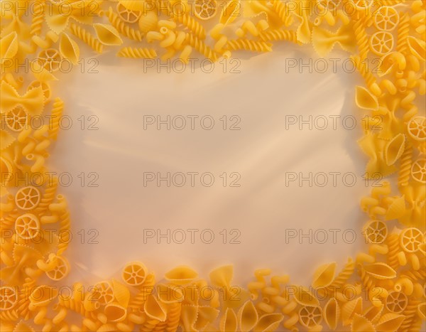 Variety of yellow pasta with blank white space in middle. Photo: Daniel Grill