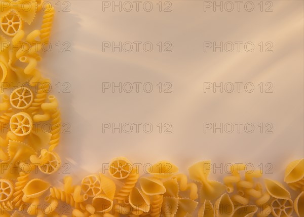 Variety of yellow pasta with blank white space in upper right corner. Photo: Daniel Grill