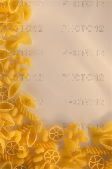 Variety of yellow pasta with blank white space in upper right corner. Photo : Daniel Grill