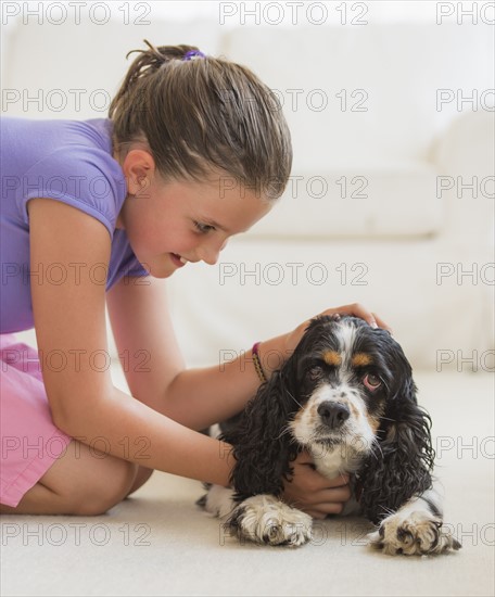 Girl (8-9) playing with her dog . Photo: Daniel Grill