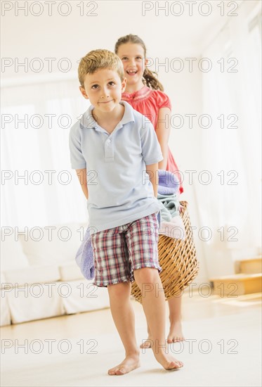 Boy (6-7) and girl (8-9) doing laundry. Photo : Daniel Grill