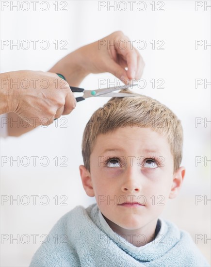 Young boy (6-7) undergoing haircut. Photo: Daniel Grill
