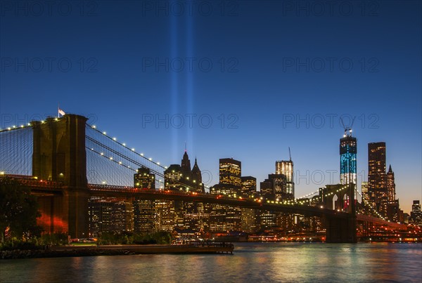 View over Hudson River towards Manhattan with September 11th memorial lights and Brooklyn Bridge. Photo : Daniel Grill